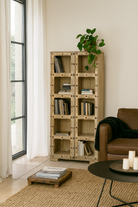 Lifestyle image of a reclaimed teak wood shelving unit with 10 compartments and iron fittings – sustainable furniture combining practicality, style, and handcrafted quality.