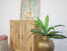 Side angle image of a carved wood furniture cabinet made from solid mango wood, hand-carved floral design, Mediterranean-style, 90 × 97 × 40 cm.