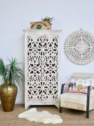Hand-carved mango wood cabinet with floral and geometric motifs in white-washed finish – carved wooden furniture with Mediterranean-inspired design.