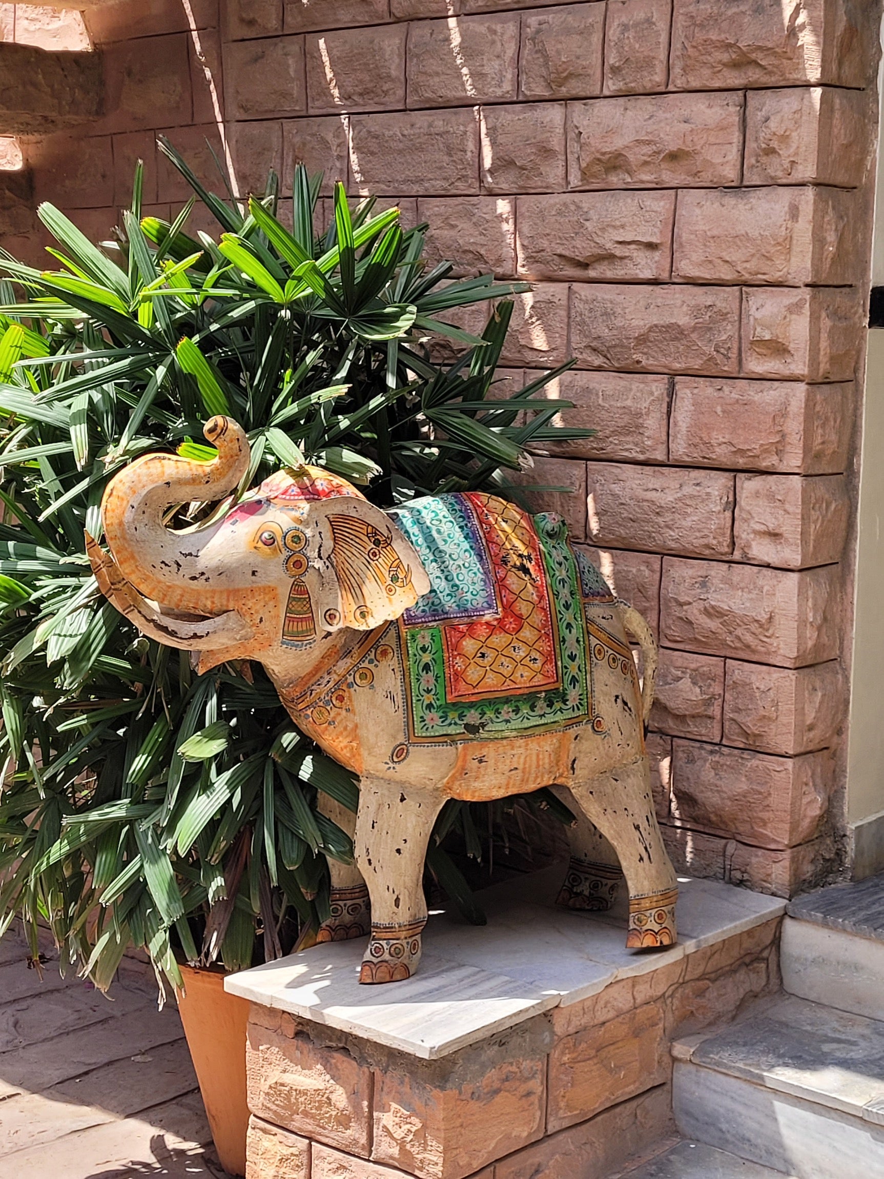 Lifestyle scene of a handcrafted metal elephant sculpture with painted finish – a unique painted metal decoration perfect for vintage home decor and artistic interiors.