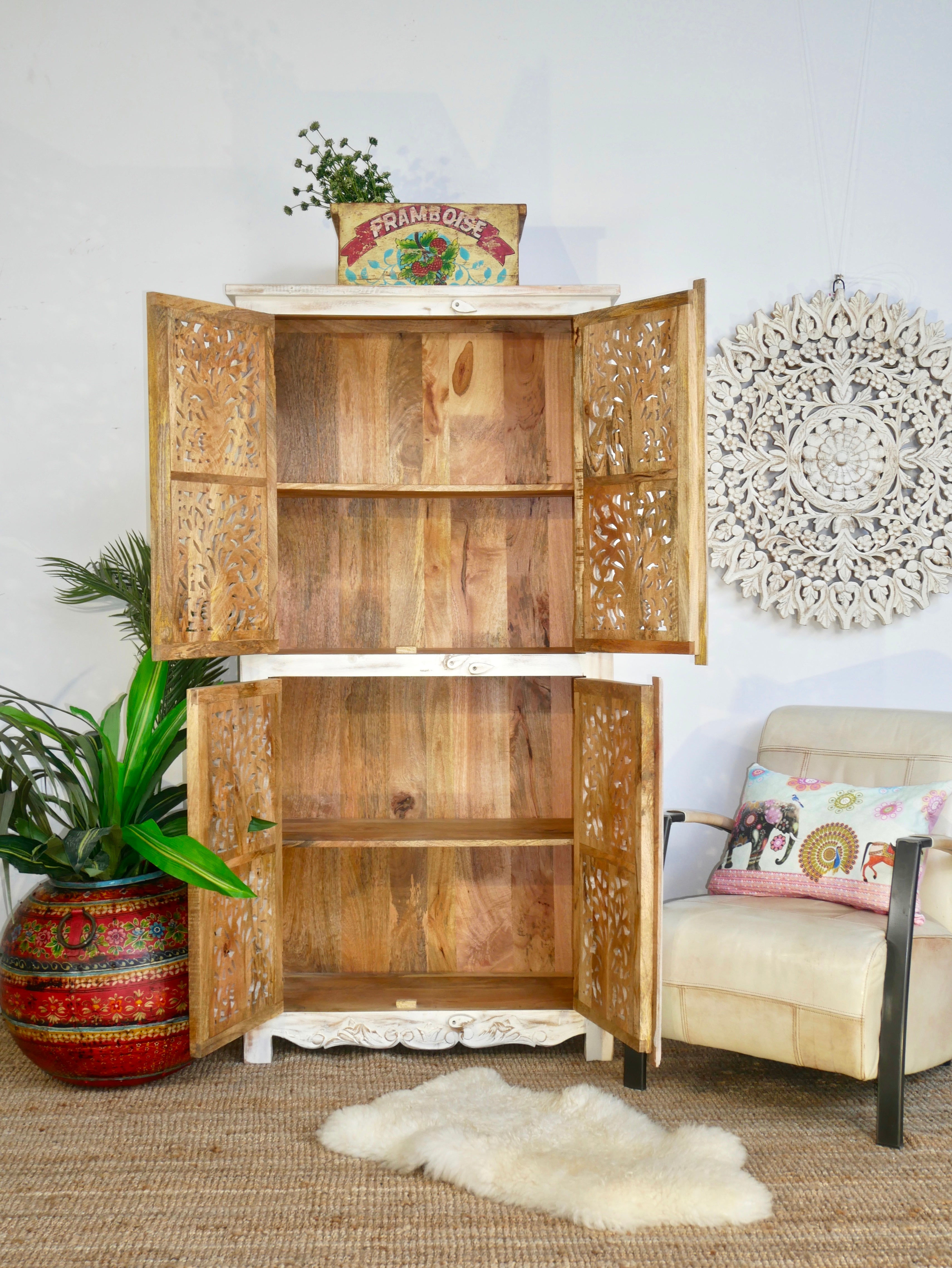 Image with open doors of a hand-carved mango wood cabinet with white-washed finish – artisanal furniture combining Mediterranean design and functional elegance.
