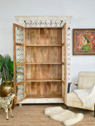 Open door image of a Handcrafted mango wood cabinet with glass-panelled doors and internal storage – carved wood furniture made from sustainable mango wood with unique natural grain.