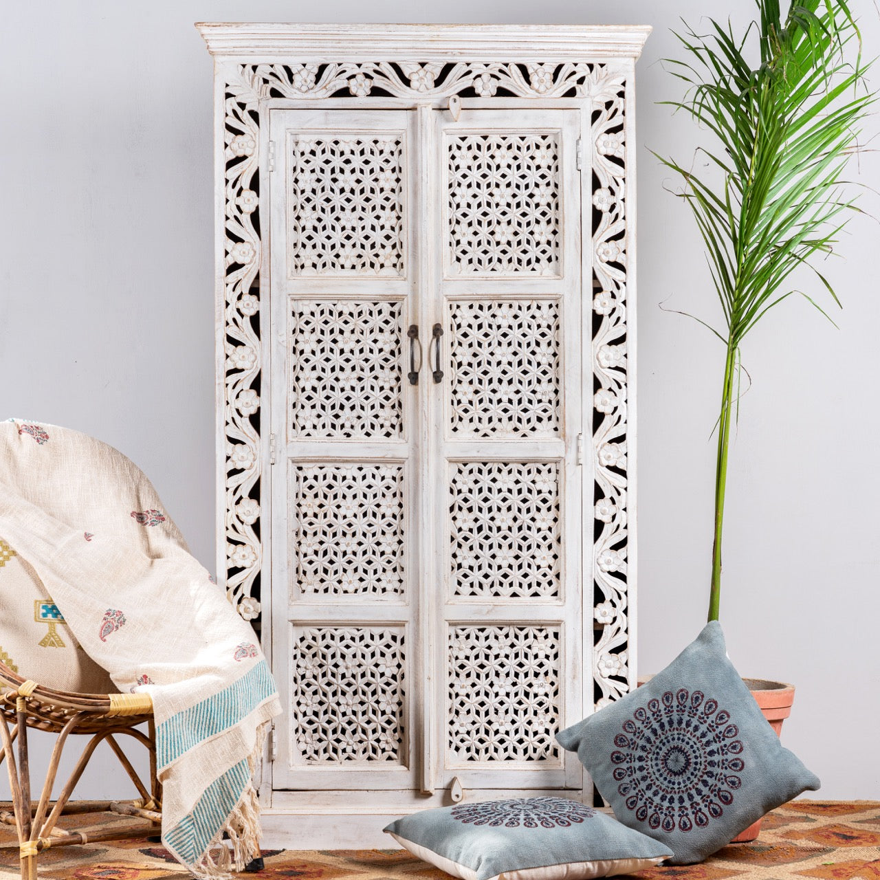 Hand-carved mango wood cabinet with floral and geometric patterns in white-wash finish – carved wooden furniture and artisanal furniture with Mediterranean charm.